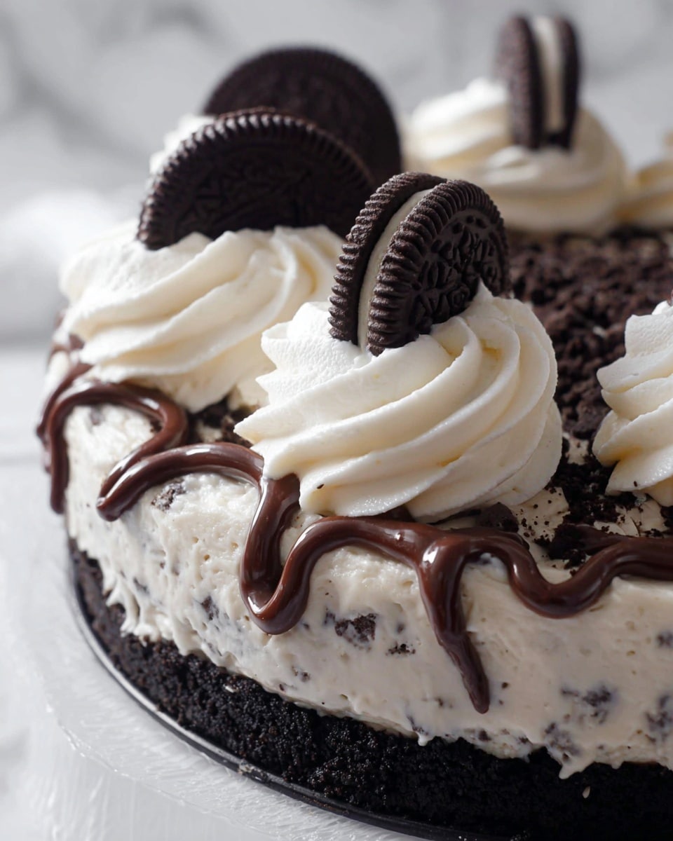 The image shows a close-up of a dessert with three main layers. The base layer is a dark, crumbly chocolate cookie crust. On top of this is a thick, creamy filling with small cookie pieces mixed in, white with black specks. Drizzled over the filling is a dark chocolate sauce arranged in a looping pattern. The top layer consists of large swirls of smooth, white whipped cream, each topped with a half of a dark chocolate sandwich cookie placed upright. The background and surface are a white marbled texture. Photo taken with an iphone --ar 4:5 --v 7